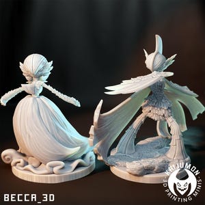 May include: Two detailed, unpainted 3D-printed figurines. One figure is a woman in a flowing gown, the other is a winged creature. The figures are on a round base. The text "BECCA_3D" is at the bottom left.