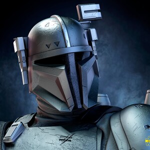 May include: A close-up of a Star Wars character wearing a weathered, silver and black helmet with a visor. The helmet has a variety of details, including a small antenna on top and a series of attachments on the sides. The character's armor is also weathered and has a similar color scheme.