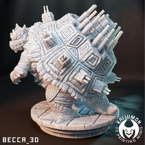May include: A white 3D printed miniature of a turtle with a detailed shell and multiple cannons on its back. The turtle is standing on a circular base with the text "KAIJUMON - 3D PRINTING MINIS" printed on it.