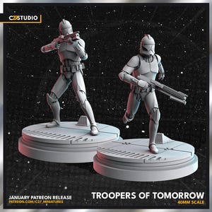 May include: Two white and gray miniature figures of futuristic soldiers, each holding a rifle, stand on circular platforms. The figures are set against a starry background. Text reads "Troopers of Tomorrow" and "40mm Scale."