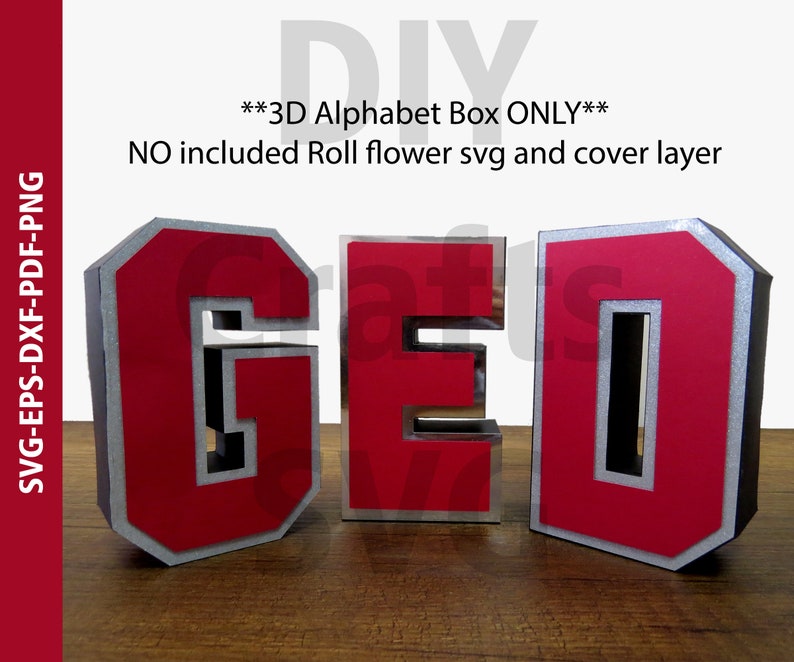 May include: Three dimensional red and silver letters spelling "GED" on a wooden surface. The letters are in a box style with a silver border.
