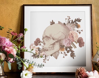 May include: A framed print of a skull with floral accents. The skull is beige and the flowers are pink and brown. The background is white.