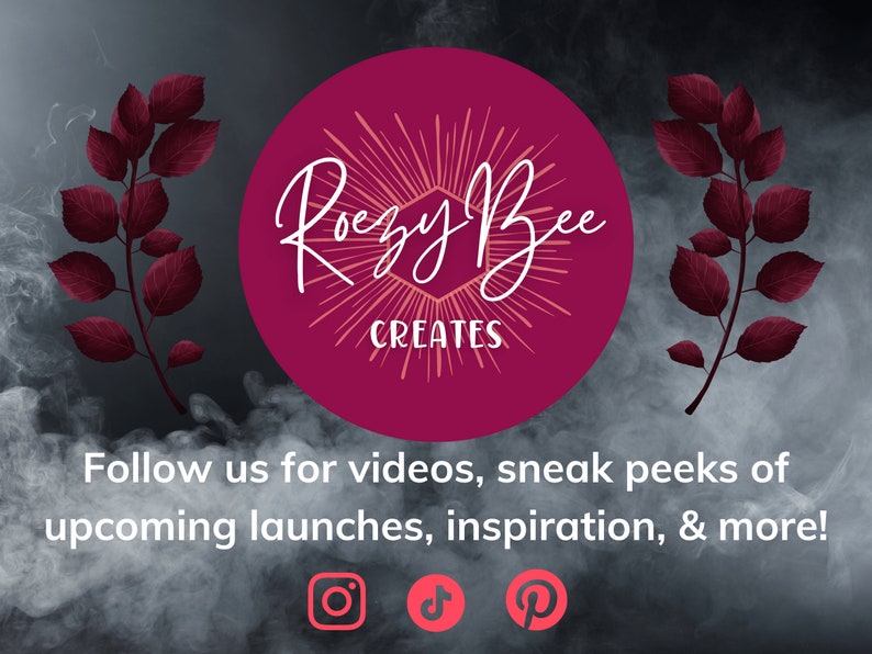 May include: A pink circle with the text "Rouzy Bee Creates" in white cursive lettering. The circle is surrounded by a burst of peach-colored rays. The background is a dark gray with a smoky effect and two dark red leafy branches on either side.