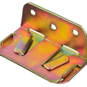 May include: A gold-toned metal bracket with two slots and four holes. The bracket is designed to connect two pieces of furniture at a 90-degree angle.