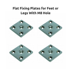 May include: Four silver metal square flat fixing plates with a single hole in the centre. The plates are designed to be used for attaching furniture legs or feet to a surface.