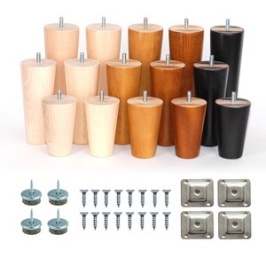 May include: Set of wooden furniture legs in various sizes and colours, including natural, brown, and black. The set also includes screws, metal plates, and felt pads.