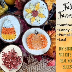 May include: String art kits on real wood slices featuring fall favorites: a sunflower, candy corn, pumpkin, and leaf. Each design is crafted with colorful thread and nails on a wooden disc. The text says "Fall Favorites".