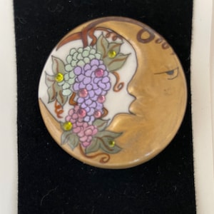 BUBBLY adds sparkle to your life. ADAGIO Gold crescent Moon pin captures clusters of grapes sparkling with amethyst crystals.