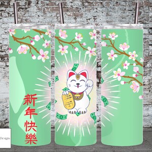 May include: A green and white tumbler featuring a cartoon image of a white cat holding a gold coin and a red "lucky" sign. The cat is surrounded by dollar bills and a green background with white cherry blossoms. The tumbler has the Chinese characters "Happy New Year" in red on the left side.