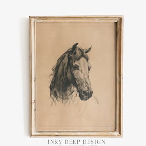 May include: A framed black and white drawing of a horse's head. The drawing is on a light brown paper background. The frame is a light wood color.
