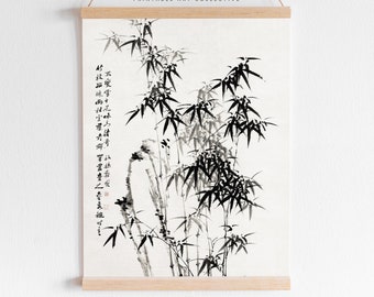 May include: Black and white ink painting of bamboo stalks with Chinese calligraphy on a white background. The painting is framed with a wooden frame and hanging from a string.