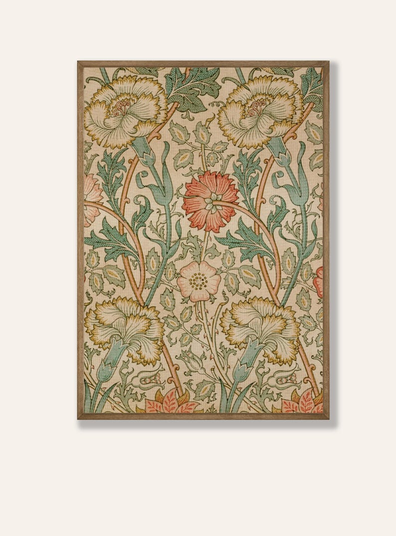 May include: A vintage floral print featuring a repeating pattern of pink, yellow, and green flowers on a cream background. The print is framed in a light brown wood frame.