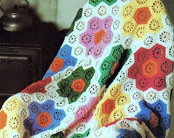 May include: A colorful crochet blanket with a white background and a variety of bright colors, including red, orange, yellow, green, blue, and pink. The blanket is made up of a repeating pattern of hexagons.