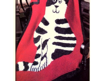 May include: A crocheted blanket featuring a black and white cat design on a red background.