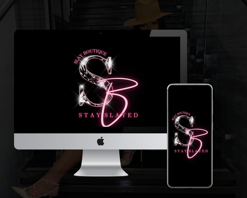 May include: A black and white mockup of a computer screen and a smartphone displaying a logo for a business called "Slay Boutique". The logo features a stylized "S" and "B" with a pink outline and a diamond-like texture. The text "Stay Slay" is written below the logo.