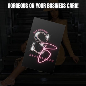 May include: A black business card with a pink and silver logo that says "Slay Boutique" and "Stay Slayed".