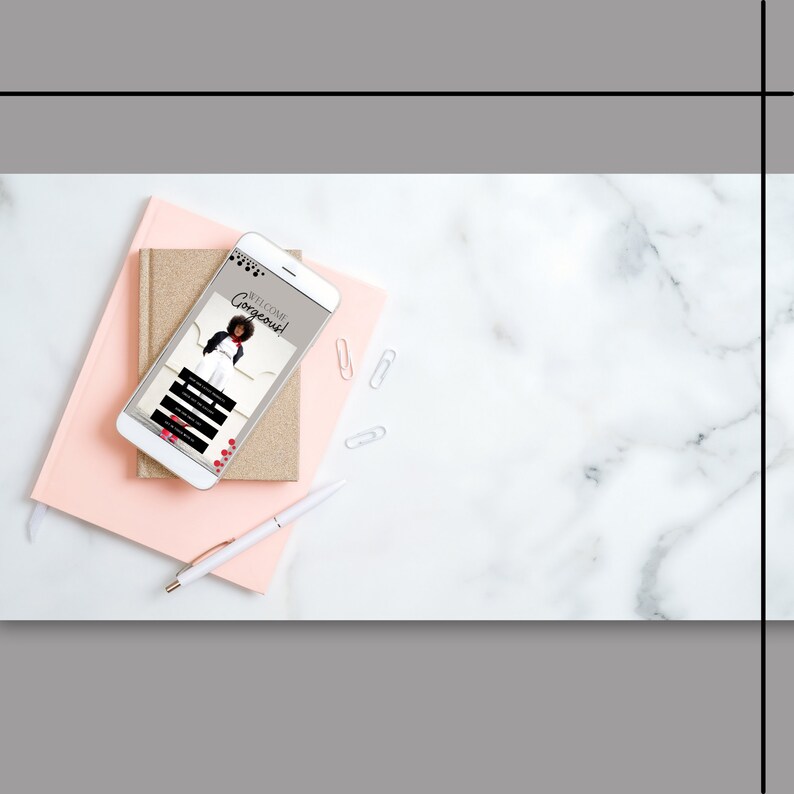 May include: A smartphone displaying a mobile app with the text "Welcome Gorgeous!" on a pink and gold notebook with a white pen on a white marble surface.
