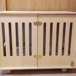 Modern dog crate with hinged door with a latch. Dog kennel, dog house, dog bed, indoor dog house, dog furniture, dog cage. Natural wood.