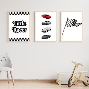 Könnte beinhalten: Drei gerahmte Drucke für ein Kinderzimmer. Der erste Druck hat einen karierten Rand und den Text "Little Racer" in Schwarz. Der zweite Druck zeigt vier schwarz-weiße Autos und ein rotes Auto. Der dritte Druck zeigt eine karierte Flagge.