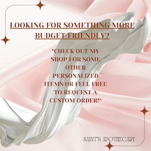 May include: Text on a pink and white background with a white swirl in the center. The text reads: "Looking for something more budget friendly? *Check out my shop for some other personalized items or feel free to request a custom order!* Saint's Apothecary"