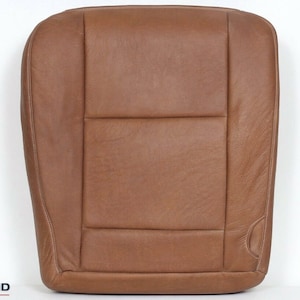 May include: Brown leather car seat back replacement. The seat back has a horizontal seam and a vertical seam down the centre.