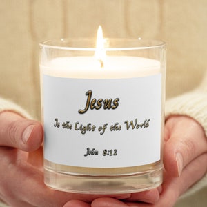 May include: A white candle with a gold label that reads "Jesus is the Light of the World" and "John 8:12".