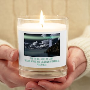 May include: A glass candle jar with a white candle inside. The jar has a label with a lighthouse image and the text "FOR YOU WILL LIGHT MY LAMP: THE LORD MY GOD WILL ENLIGHTEN MY DARKNESS. PSALM 18:28".