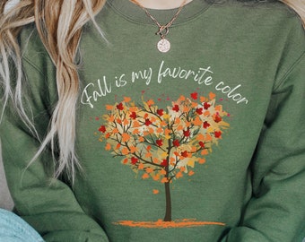 May include: A green sweatshirt with the text "Fall is my favorite color" and a heart-shaped tree with fall leaves.