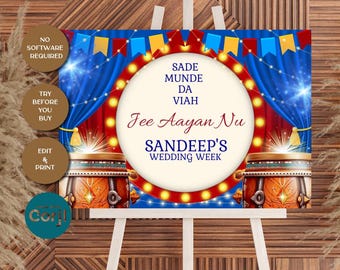 Op de afbeelding: Een trouwbord op een ezel met een feestelijk ontwerp. Het bord bevat tekst in een cirkelvormig kader met een rode en gele lichtrand. De achtergrond omvat blauwe gordijnen, decoratieve drums en de tekst "Sandeep's Wedding Week."