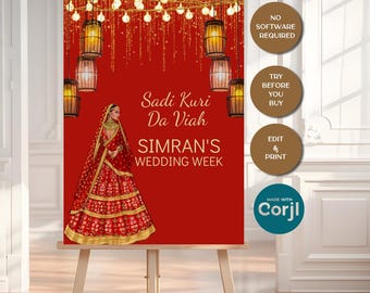 Op de afbeelding: Een rood trouwbord op een ezel met de tekst "Sadi Kuri Da Viah SIMRAN'S WEDDING WEEK". Het bord heeft een decoratieve illustratie van een vrouw in een rode trouwjurk, met hangende lantaarns en lichtslingers.