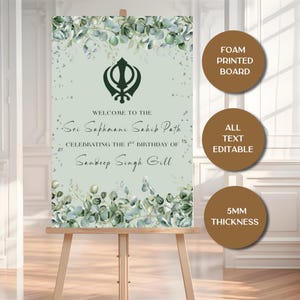May include: A welcome sign on an easel with text that reads "Welcome to the Sri Sukhmani Sahib Path, celebrating the 1st birthday of Sandeep Singh Gill." The sign has a floral design and the text "Foam Printed Board", "All Text Editable", and "5mm Thickness".