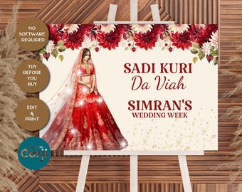 Op de afbeelding: Een bord op een ezel met een bloemenontwerp en een afbeelding van een vrouw in een rode trouwjurk. Het bord leest "Sadi Kuri Da Viah Simran's Wedding Week". Extra tekst omvat "No Software Required", "Try Before You Buy" en "Edit & Print".
