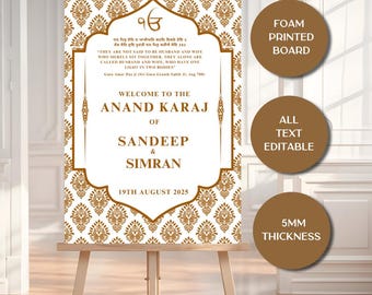 May include: A decorative wedding sign on an easel. The sign features a gold and white floral pattern with text that reads "Welcome to the Anand Karaj of Sandeep & Simran, 19th August 2025." The sign is a foam printed board with a 5mm thickness.