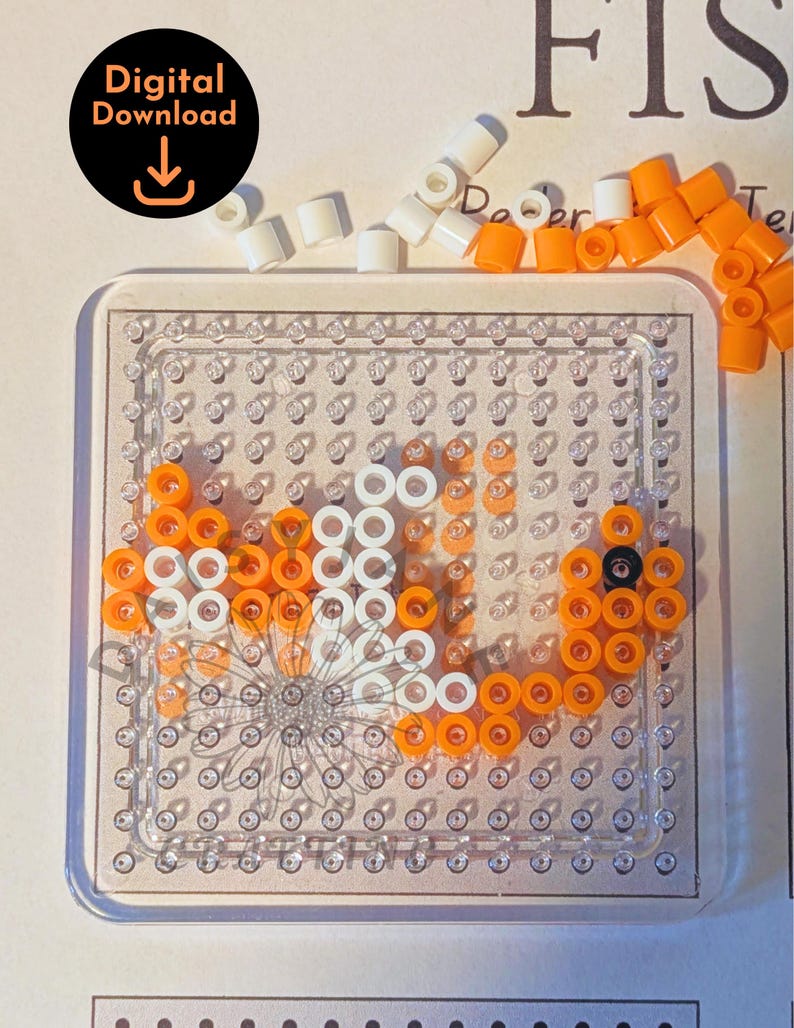 May include: A clear plastic pegboard with a fish design made from orange, white, and black beads. The image includes a digital download icon in the upper left corner. The word "FIS" is visible in the background.