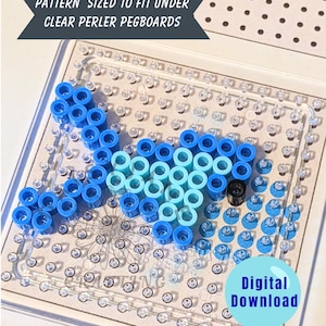 May include: A clear Perler bead pegboard with a fish design made of blue and light blue beads. The design is on a white background with the text "PATTERN SIZED TO FIT UNDER CLEAR PERLER PEGBOARDS" and "Digital Download".