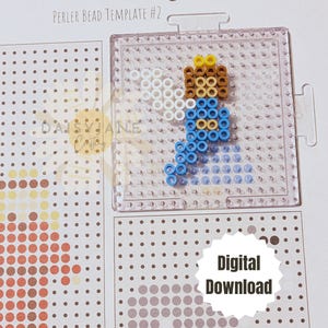 Peut inclure: Un mod&egrave;le de t&eacute;l&eacute;chargement num&eacute;rique pour une sc&egrave;ne de la Nativit&eacute; r&eacute;alis&eacute;e avec des perles Perler. Le mod&egrave;le montre un ange bleu et blanc avec une aur&eacute;ole dor&eacute;e.