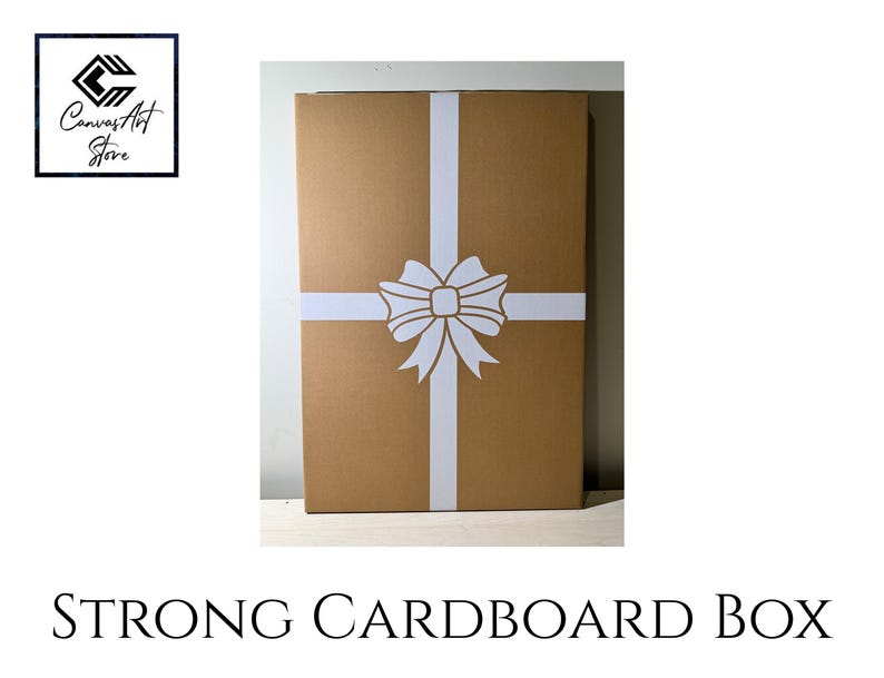 May include: A rectangular brown cardboard box featuring a white ribbon graphic printed in a cross pattern with a central bow. The box is labelled with the text Canvas Art Store in the top left corner and Strong Cardboard Box at the bottom.