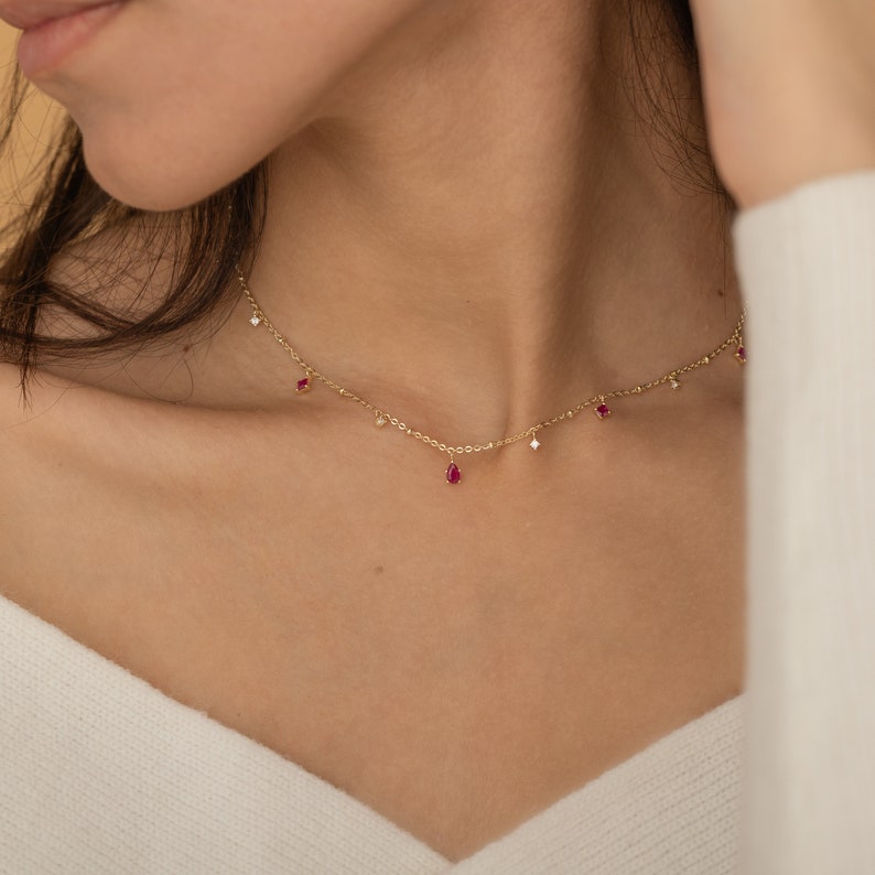 a close up of a woman wearing a necklace