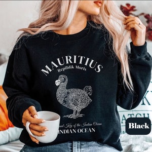 May include: Black sweatshirt with a white graphic of a dodo bird and the text "MAURITIUS Repiblik Moris and Key of the Indian Ocean INDIAN OCEAN".