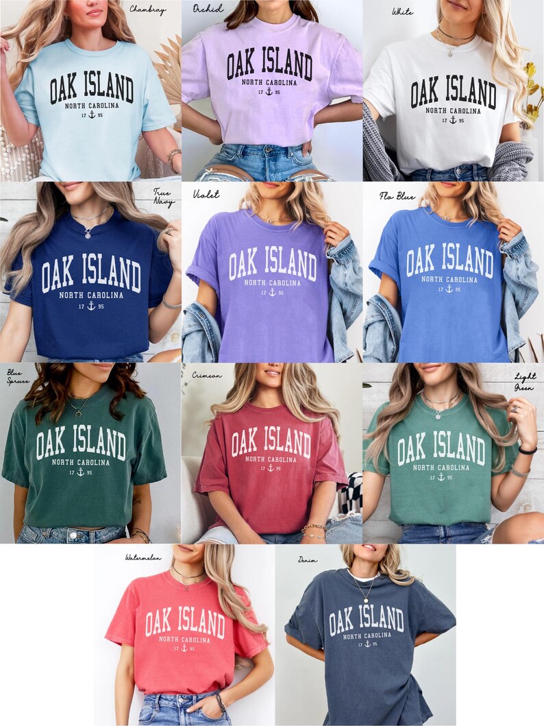 May include: A selection of short-sleeved t-shirts in diverse colours, each bearing the text "OAK ISLAND NORTH CAROLINA" in a bold, arched font. The shirts have a vintage, slightly faded look, with a nautical anchor graphic.
