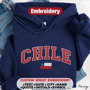 May include: A navy blue hooded sweatshirt featuring the word CHILE embroidered in red with white outlines in an arched font. Below the text is a small embroidered Chilean flag. The text Embroidery appears at the top, and custom wrist embroidery options are listed at the bottom.