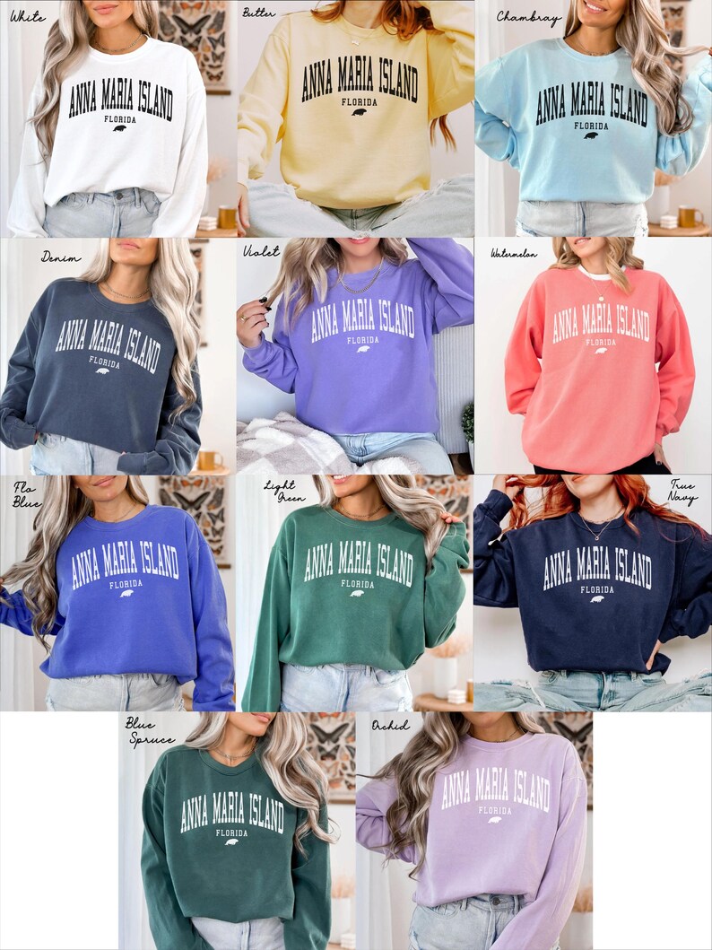 May include: A collection of long-sleeved sweatshirts in various colors, each featuring the text "ANNA MARIA ISLAND FLORIDA" in a bold, white font. The sweatshirts are in shades like white, yellow, blue, green, and purple.