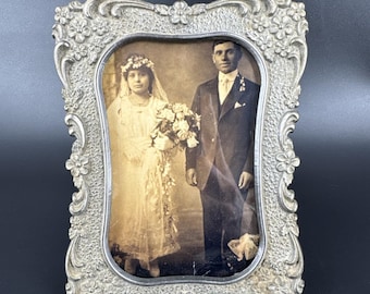 Retrato vintage de novia y novio, pareja casada, marco floral de metal adornado. LEER