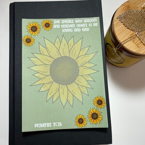 May include: A green card with a large yellow sunflower and smaller sunflowers around the edges. The card has the text "She speaks with wisdom and teaches others to be loving and kind" and "Proverbs 31:26".