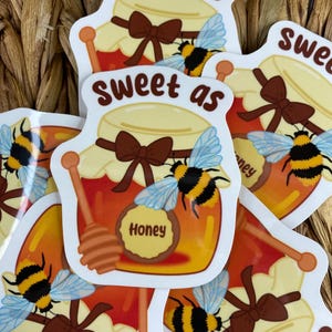 May include: Five stickers with a honey jar and bee design. The stickers say "Sweet as" and "Honey".