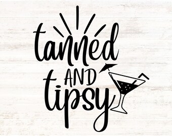 May include: Black and white graphic text design on a white wood background. The text reads "Tanned and Tipsy" with a stylised cocktail glass and umbrella.