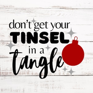 May include: White wood background with a black and white graphic that says "don't get your tinsel in a tangle" with a red Christmas ornament.