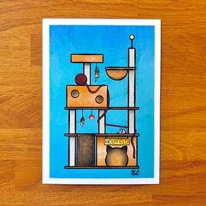 May include: A multi-level cat tree against a blue background. The cat tree has a platform with a red ball of yarn, a platform with a small toy mouse, and a top platform with a cat bed labelled "HOLYFIELD".