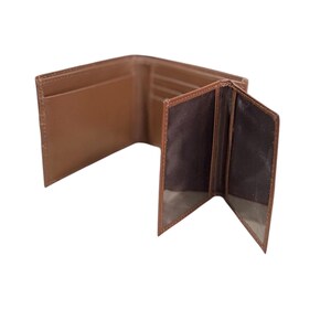 May include: A brown leather wallet with multiple compartments and folds.