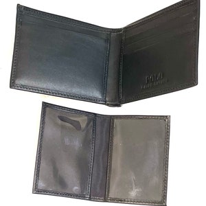 May include: Black leather bi-fold wallet with a Polo Ralph Lauren logo on the inside. The wallet has multiple card slots and a clear plastic ID window.